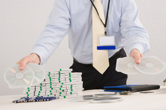 Mid section view of a businessman showing CD