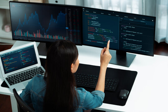Top view young Asian IT developer creating with typing online information on pc with coding program data of website application, wearing jeans shirt. surround by safety analysis two screen. Stratagem.