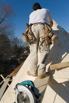 Carpenter working on the turret of a house