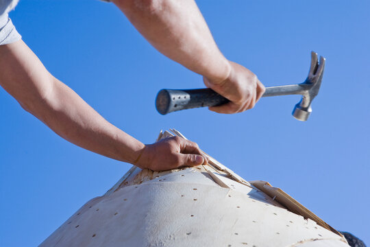 Carpenter working on the turret of a house