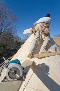 Carpenter working on the turret of a house