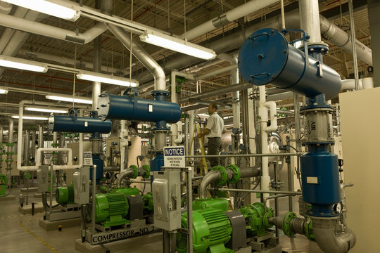Engineer with air compressors in water treatment plant