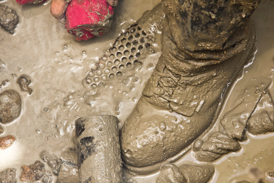 Construction worker's shoe in mud