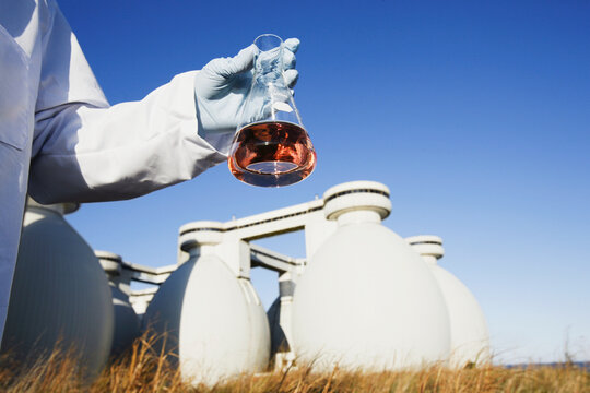 Scientist holding a flask of water sample