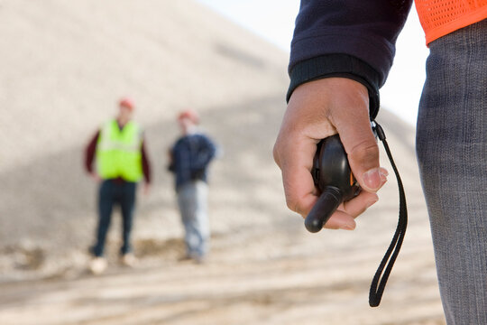 Engineer holding a walkie-talkie