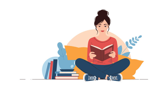 Young woman sitting cross legged on the floor reading an interesting book with several stacks of books behind her for study.