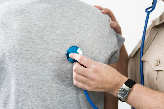 Emergency Medical Service officer checking pulse of a patient
