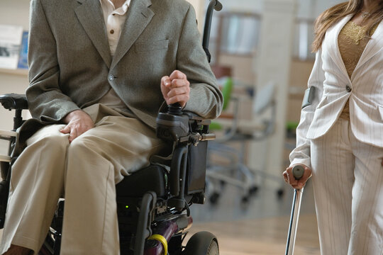 Man with Cerebral Palsy and woman with cane