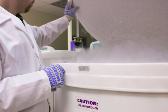 Scientist working on a liquid nitrogen container