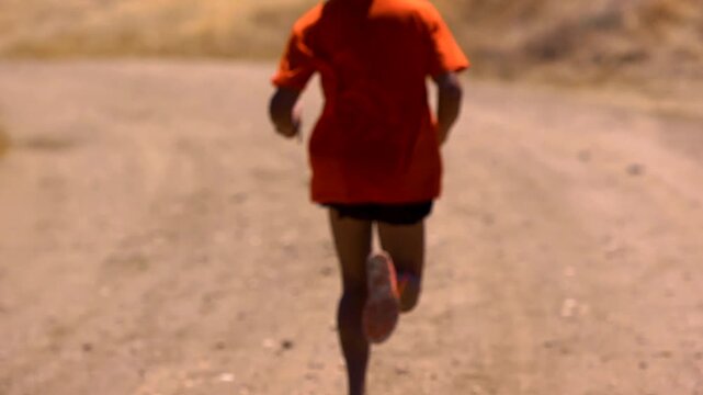 Close up of marathon runner training for race on a dirt trail