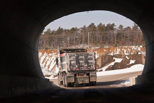 Dump truck going through a tunnel at a gravel pit