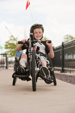 Boy with cerebral palsy in a racing bike