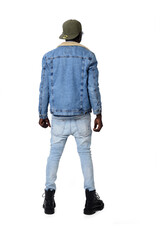 Fototapeta premium Portrait of a young man in street clothes from behind on a white background.