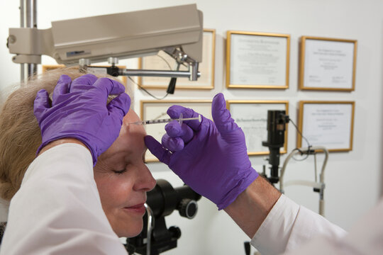 Ophthalmologist giving a Botox injection to a patient