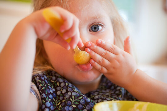 Girl feeding herself in a disability accessible home