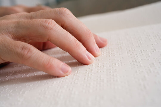 Close up of fingers on Braille