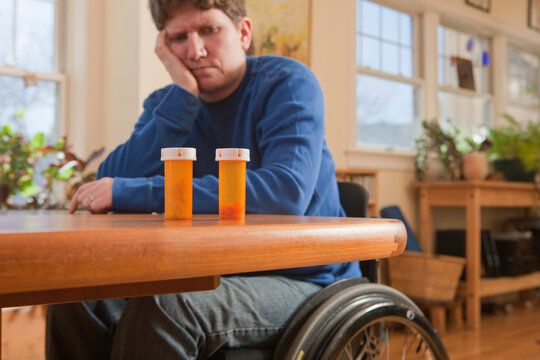 Woman with multiple sclerosis in a wheelchair choosing between subscription medicines