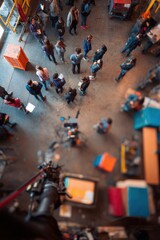 Obraz premium People standing in a spacious workshop or warehouse. Group of man and woman participating in a community project or creative event. High angle view of individuals in an industrial area.