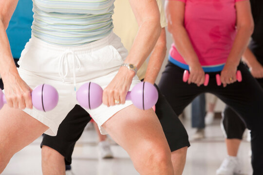 Senior exercise class working with dumbbells