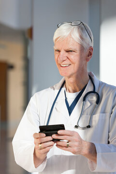 Doctor text messaging on his smartphone