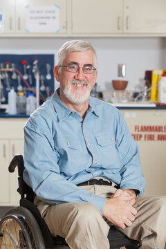 Portrait of an engineering professor in a wheelchair with Muscular Dystrophy in a chemistry lab