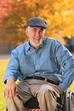 Portrait of a man with Muscular Dystrophy sitting in a wheelchair and smiling