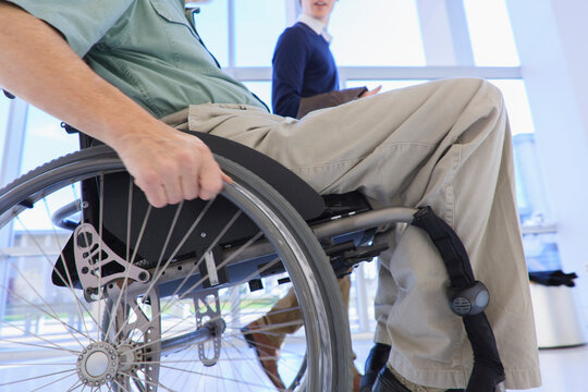 Man in a wheelchair with Muscular Dystrophy using a hallway