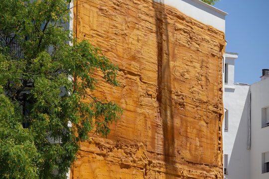 Exterior thermal insulation system installation on residential building facade during energy efficiency renovation