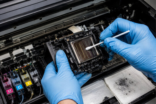 Technician Cleaning Clogged Printhead on Large Format Inkjet Printer