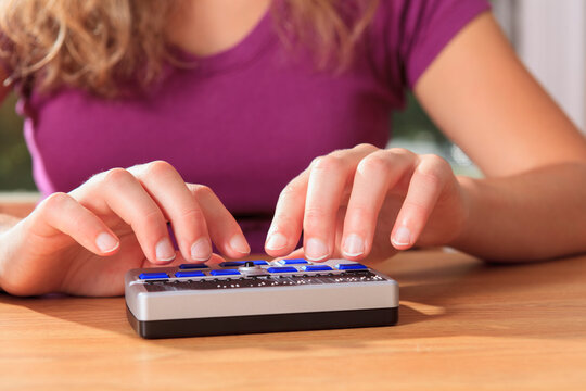 Student with visual impairment using her Braille display to communicate