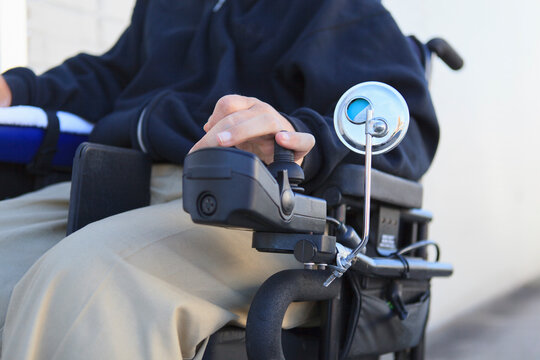 Man with spinal cord injury using his motorized wheelchair