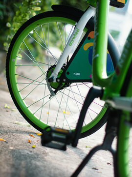 Close-up detail of Anywheel Bangkok BMA shared bicycle rear wheel guard with colorful illustrated graphic design artwork and saddle seat post