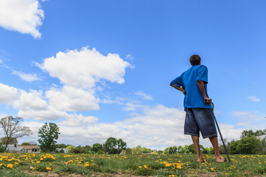 Man with Traumatic Brain Injury standing in a field of flowers