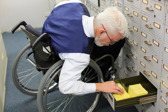 Man with Muscular Dystrophy in a wheelchair working in an office
