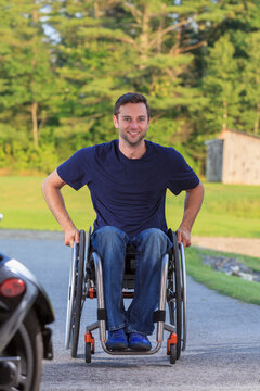 Man with spinal cord injury in wheelchair coming to work