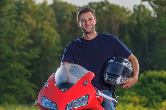 Man with spinal cord injury on his custom adaptive motorcycle with helmet