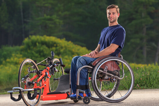 Man with spinal cord injury in his wheelchair with his custom adaptive hand cycle