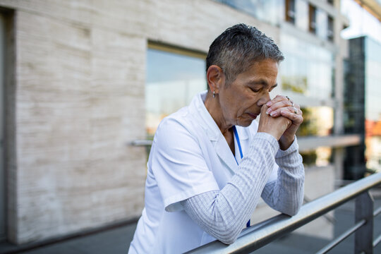 Stressed nurse taking a break outside hospital