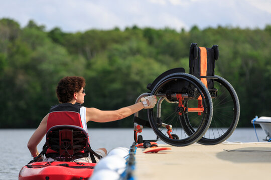 Woman with a Spinal Cord Injury learning how to use a kayak