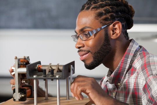 Student who had Spinal Meningitis with a hearing aid, working on an electromagnetism experiment in