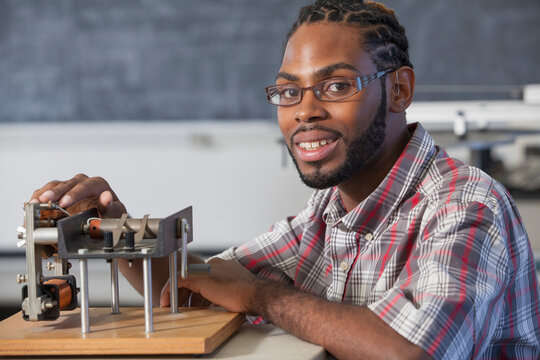 Student who had Spinal Meningitis and with hearing impairment working on an electromagnetism