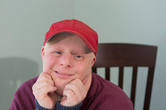 Portrait of a happy young man with Down Syndrome at home