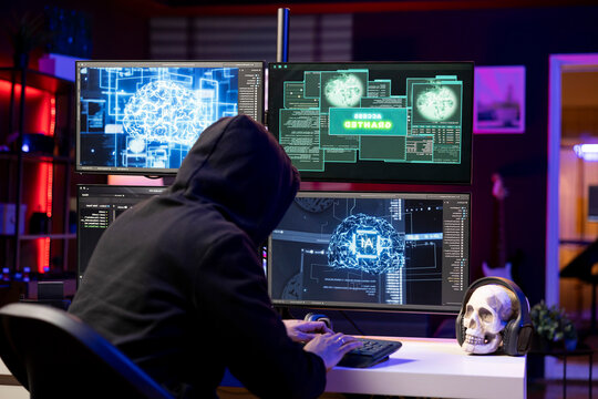 Hooded hacker typing on PC keyboard, using AI to break into secure computer systems and bypass security, rogue engineer uses neural networks to attack weak spots in company networks.