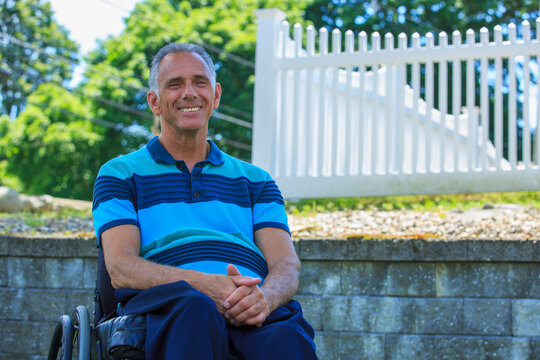 Smiling portrait of man with a Spinal Cord Injury in wheelchair