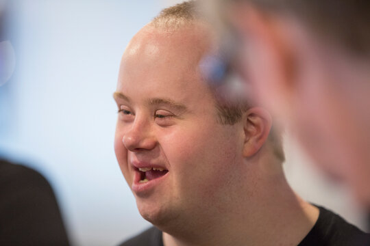Waiter with Down Syndrome talking to other colleagues