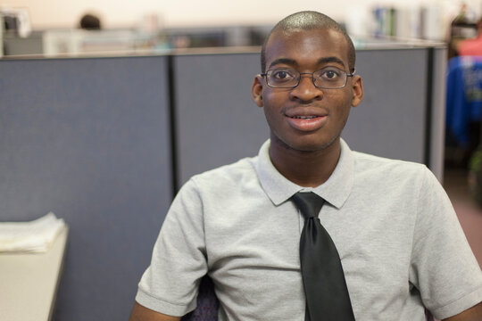 Portrait of African American man with Autism working in an office