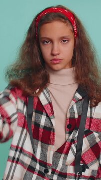 I will not say anything. Frightened shocked teenager child girl kid closing her mouth with hand, looking intimidated scared at camera, gestures no, refusing to tell terrible secret, unbelievable truth