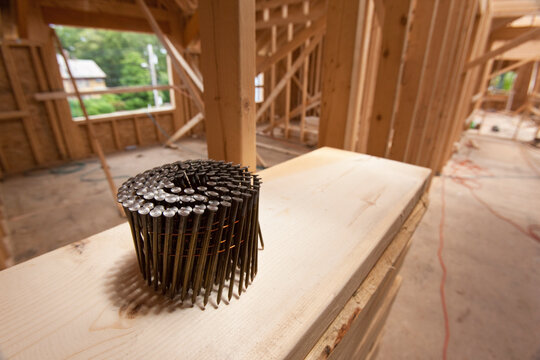 Coil of nails on a board at a construction site