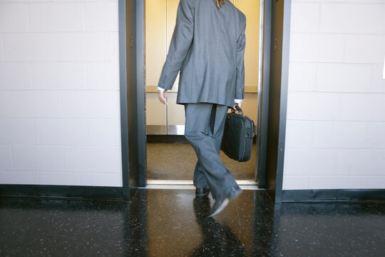 A man stepping into an elevator