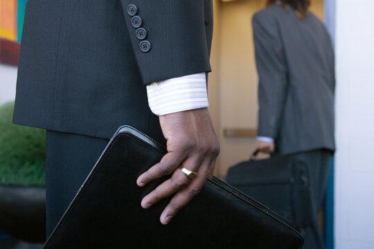 Close up of a business man holding a folder